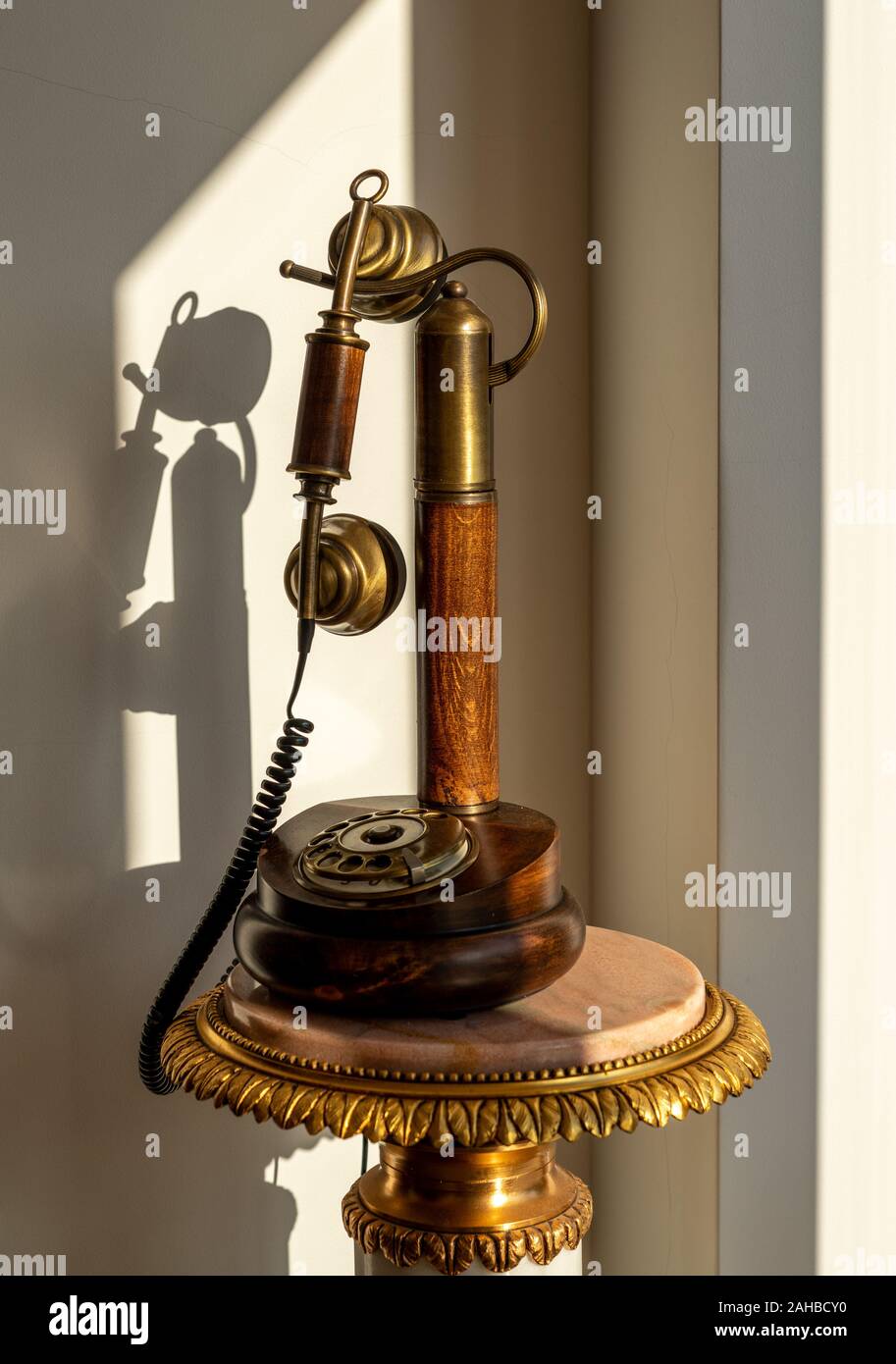Tradizionale di antiquariato in legno lucido telefono e ricevitore sulla tavola di marmo Foto Stock