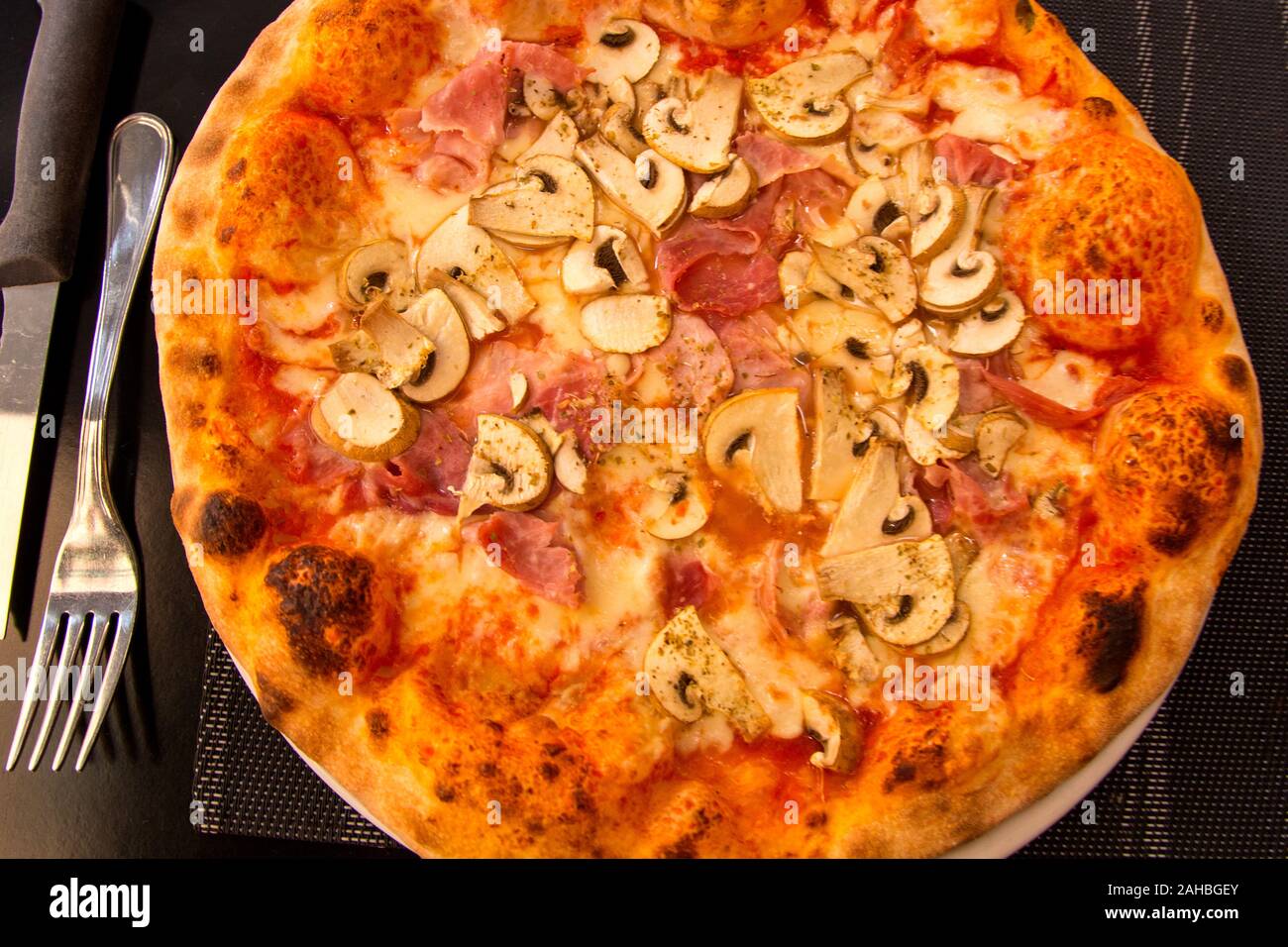 Una pizza con prosciutto immagini e fotografie stock ad alta