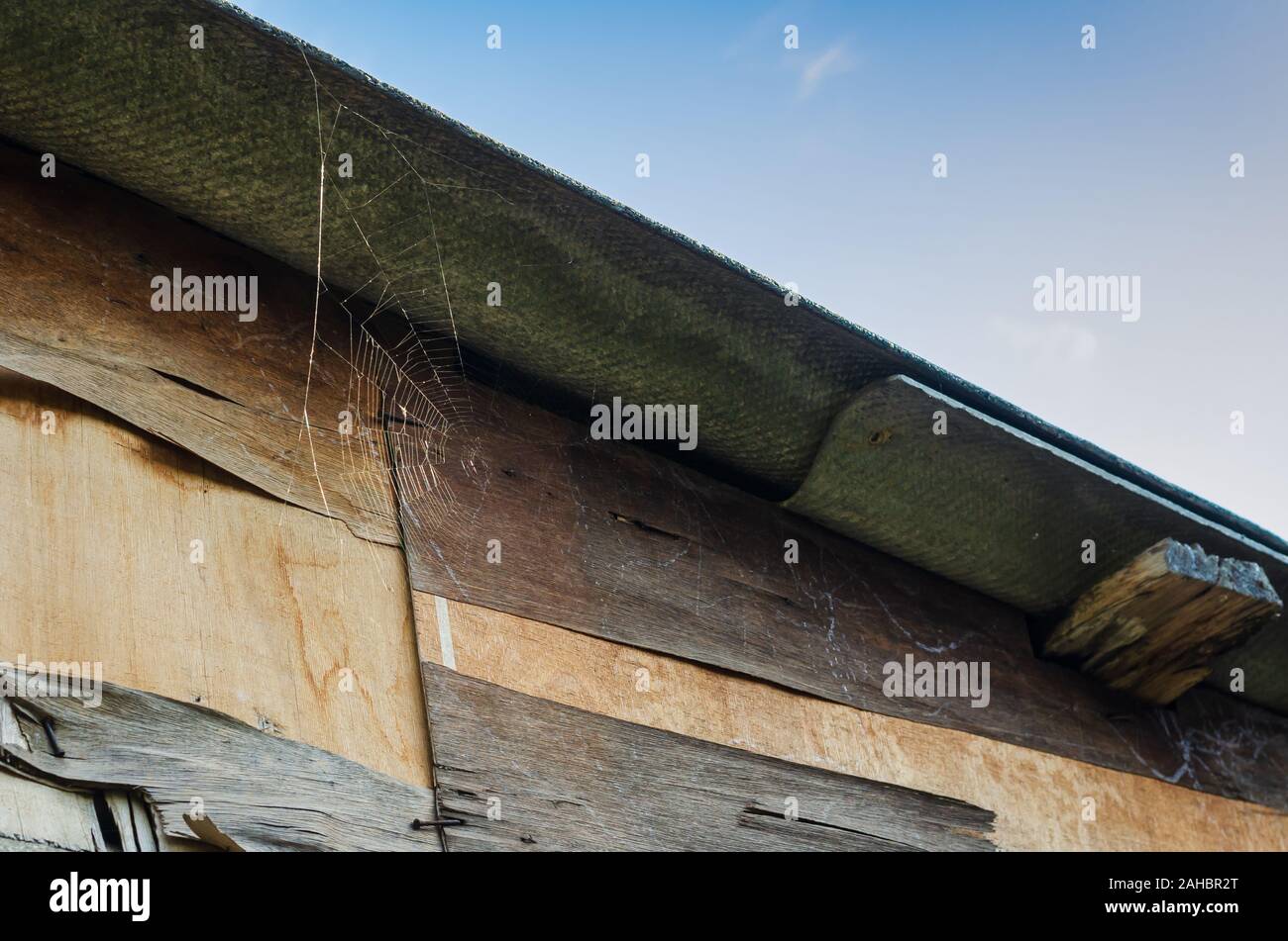 Il tetto del vecchio fienile contro il cielo. Scatto dal basso verso l'alto. Senza le persone. Close-up. Messa a fuoco selettiva. Orizzontalmente Foto Stock