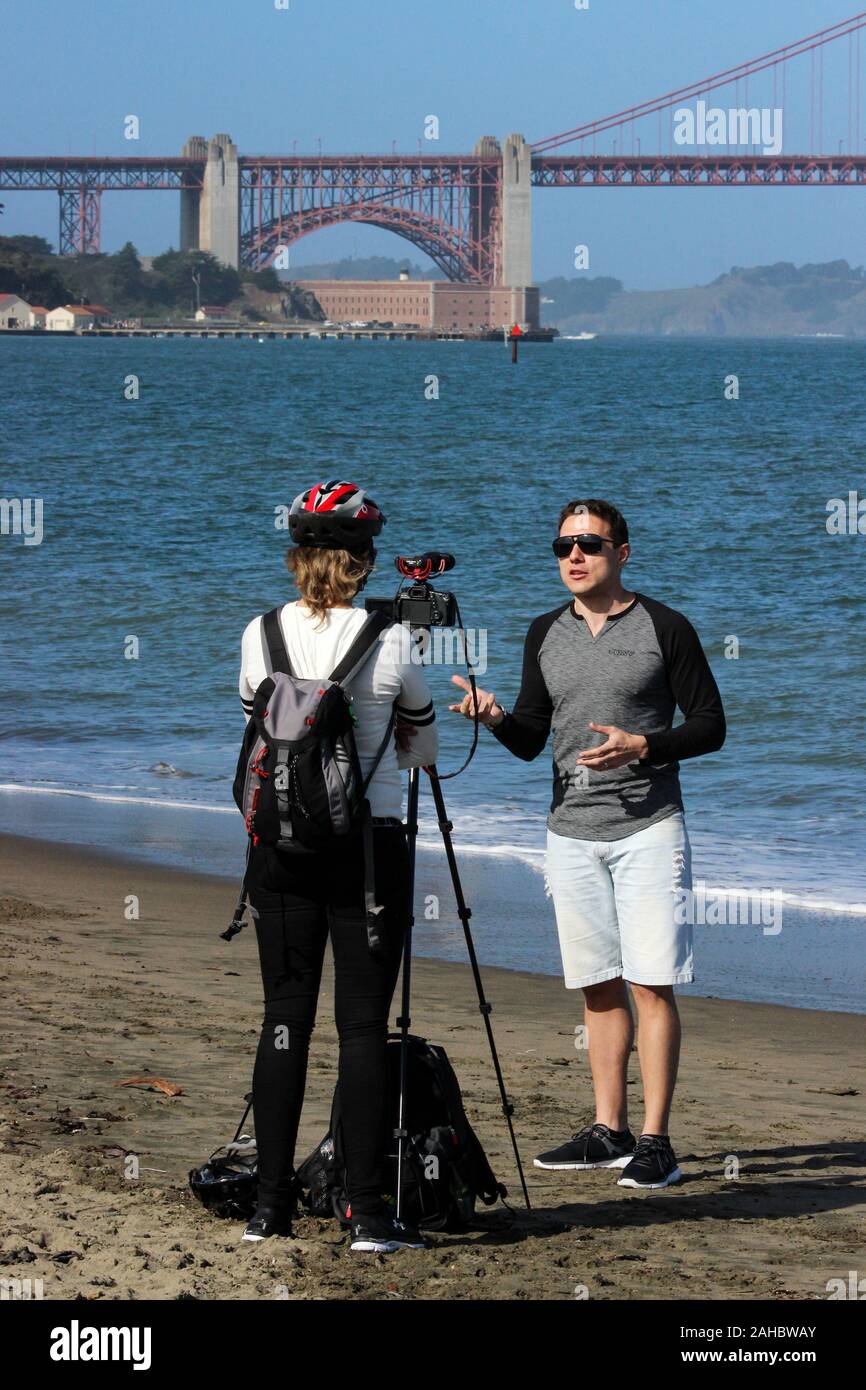 Assunto il video blogger (vlogger) su Crissy Field Beach area ricreativa di San Francisco, Stati Uniti d'America Foto Stock