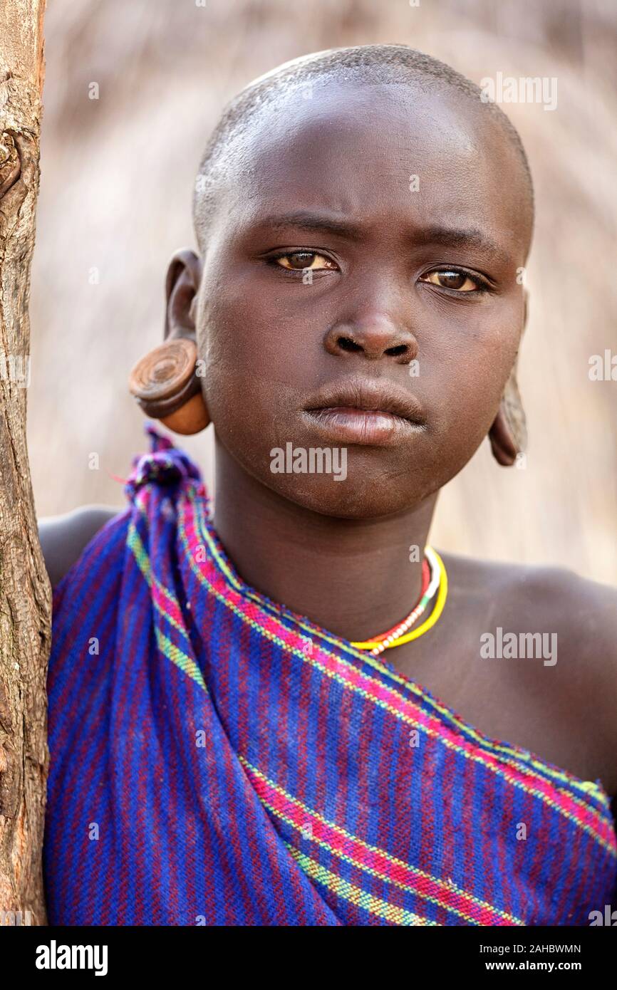 Ritratto di una tribù suri donna con orecchioni allargata e grandi orecchini, valle dell'Omo, Etiopia Foto Stock