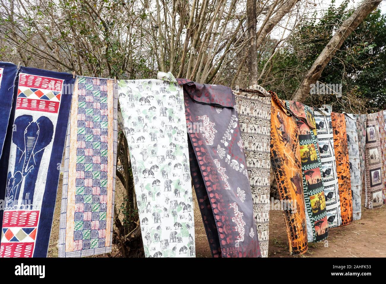 African traditional tessili, tessuti, materiali, panno appeso su una linea all'aperto per la vendita in un mercato di strada in pellegrini resto, Sud Africa Foto Stock
