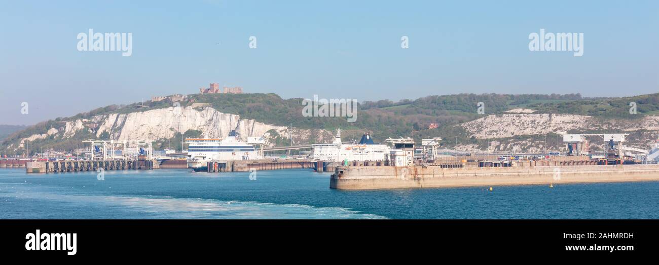 Dover, Inghilterra; 5 maggio 2018; Panorama del Porto con due traghetti inserito. Scogliere Bianche di Dover e del Castello di Dover in background. Luminoso cielo blu chiaro Foto Stock