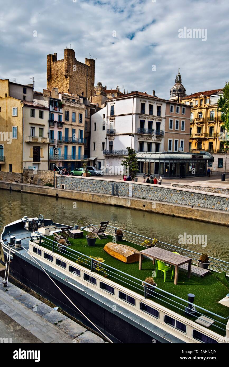 Narbonne, Francia - 6 maggio 2016 Vista sul Canal Robine nel centro della città di Narbonne, casa galleggiante è a foregrounf e Narbonne Cattedrale e als città sede, Foto Stock
