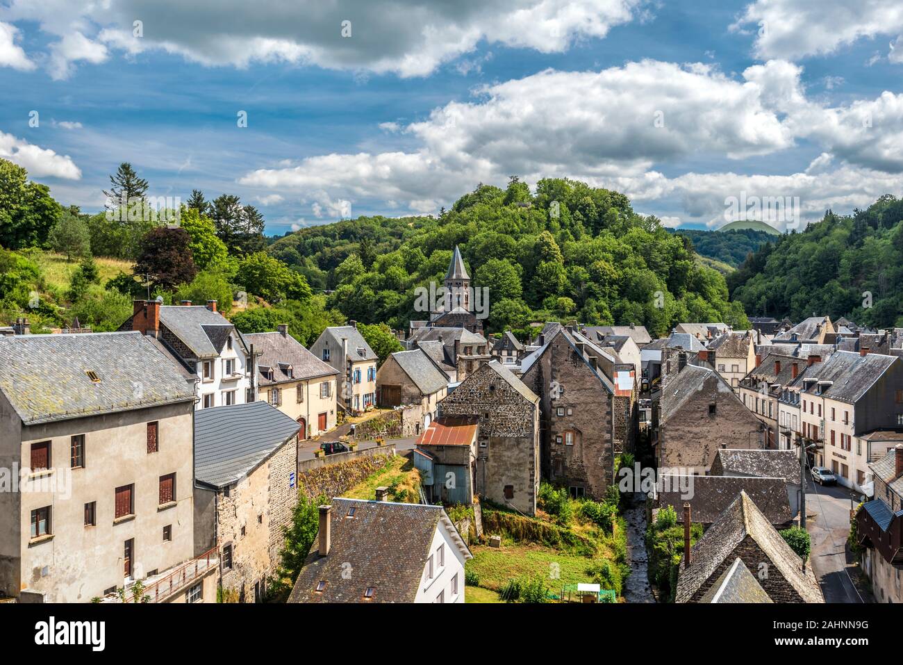 Vista sul villaggio di Orcival in Valle Sioulot, la Torre della Basilica di Notre Dame si trova a bacground . Puy-de-Dome dipartimento in francese Auvergne. Foto Stock