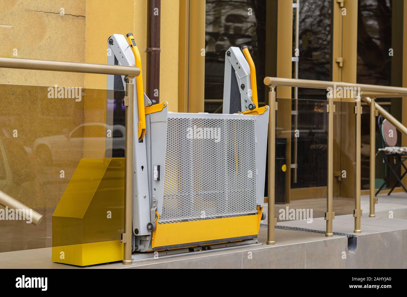 Electric rampa per disabili. Un grigio-rampa di colore giallo al di fuori del palazzo pubblico. Senza le persone. Messa a fuoco di pulitura. Paesaggio formato foto Foto Stock