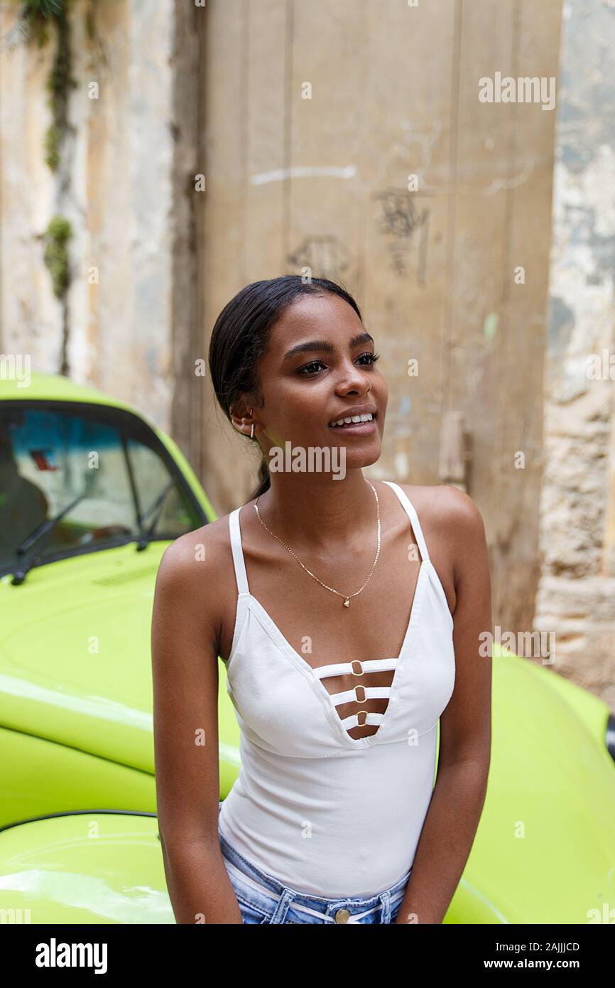 Giovane donna cubana e verde auto, Havana Foto Stock