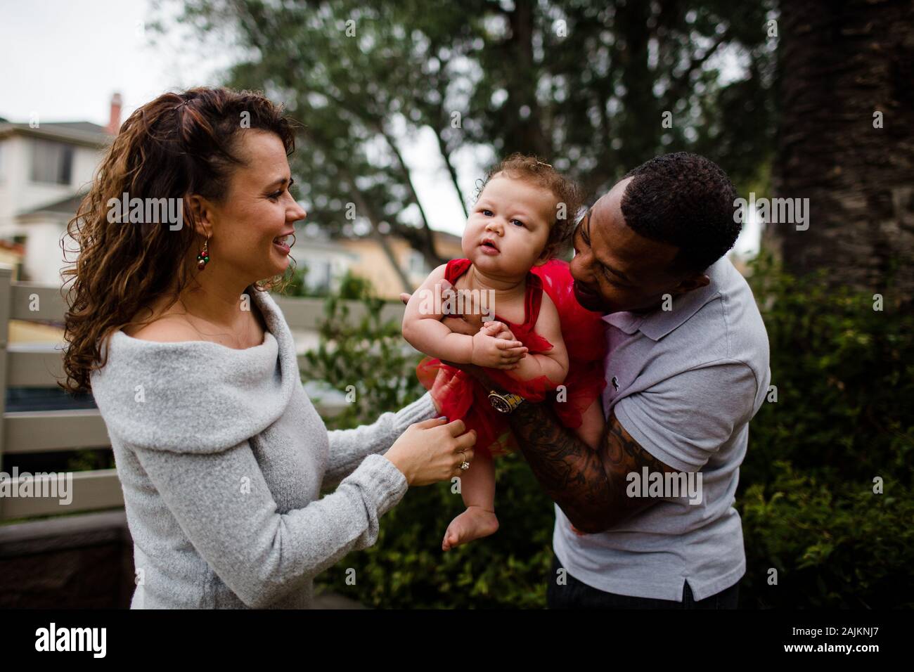 Coppia biraciale che tiene & sorride a Baby Foto Stock