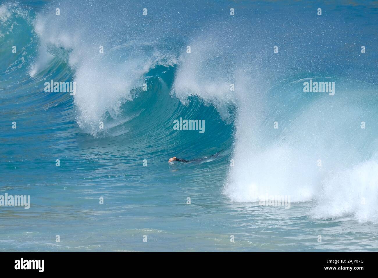 vista ad alto angolo di una persona che si tuffa in una grande onda Foto Stock