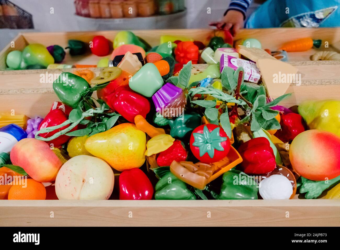 Bambina gioca con falsi in plastica per alimenti. Foto Stock