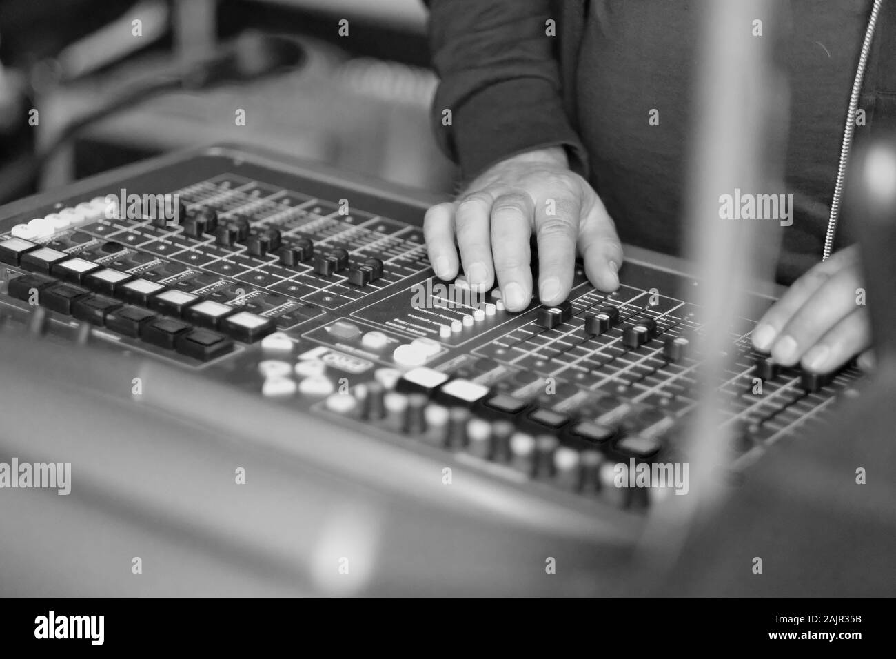 Le mani del tecnico del suono sulla console di miscelazione durante il concerto Foto Stock