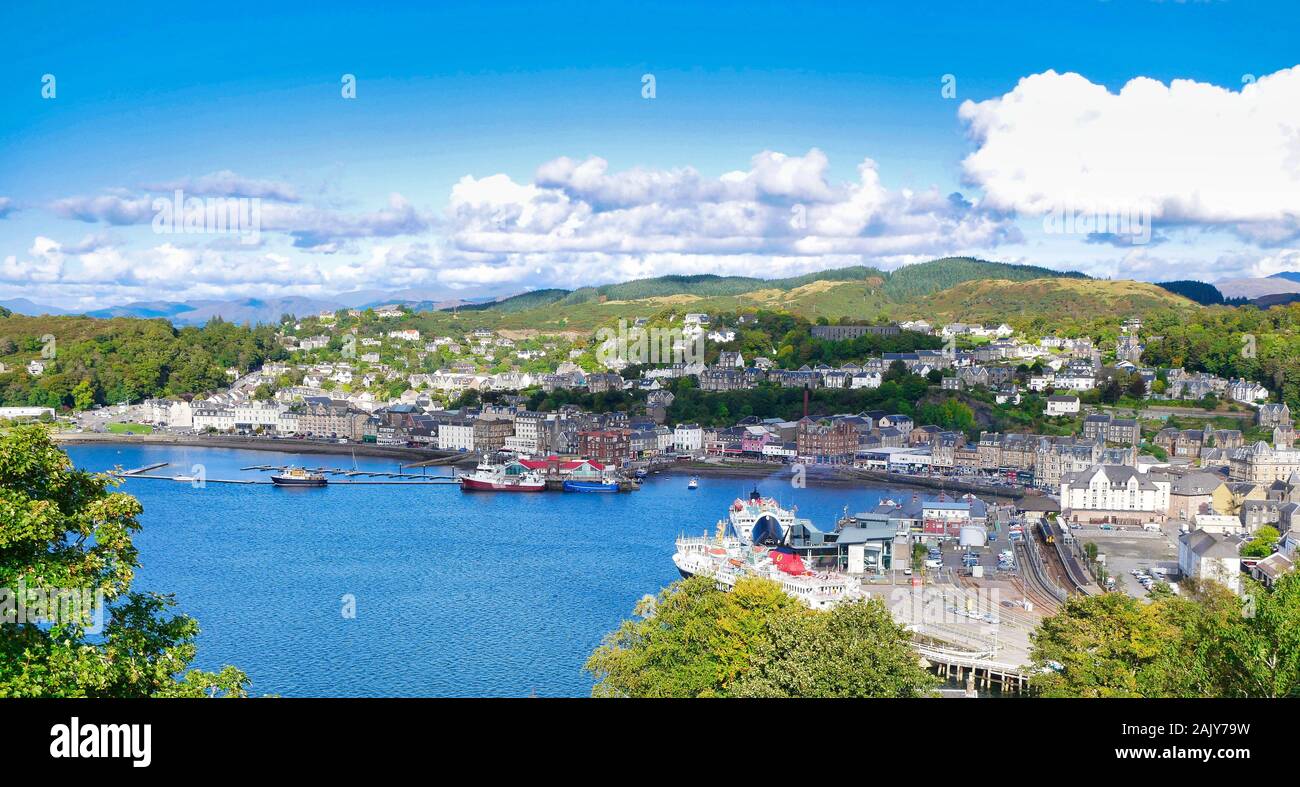 Una vista panoramica di Oban sulla costa ovest della Scozia, che mostra la città, dai terminal dei traghetti e delle colline in background, preso in una giornata di sole Foto Stock