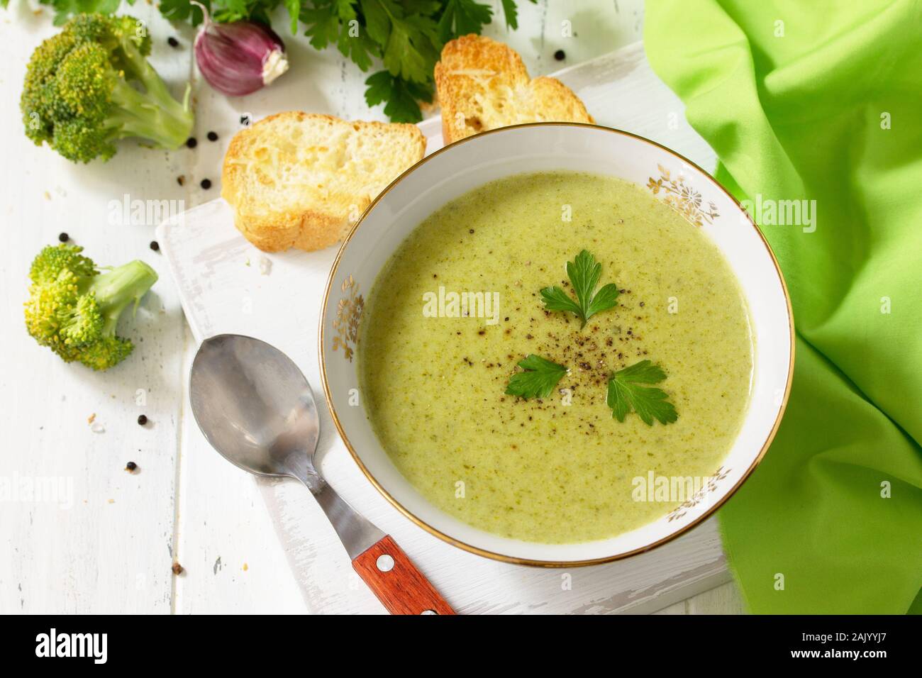 Menù dietetici. Mangiare sano concetto. Purea di zuppa di broccoli con crostini di aglio su un di legno bianco tavolo da cucina. Foto Stock
