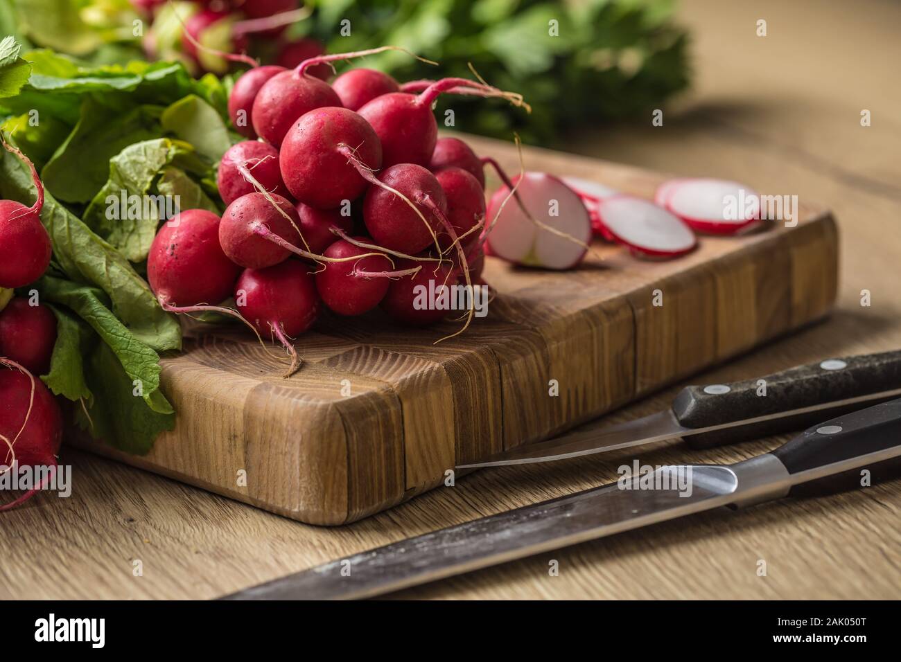 Freschi mazzi di ravanello prevista su un tavolo da cucina Foto Stock