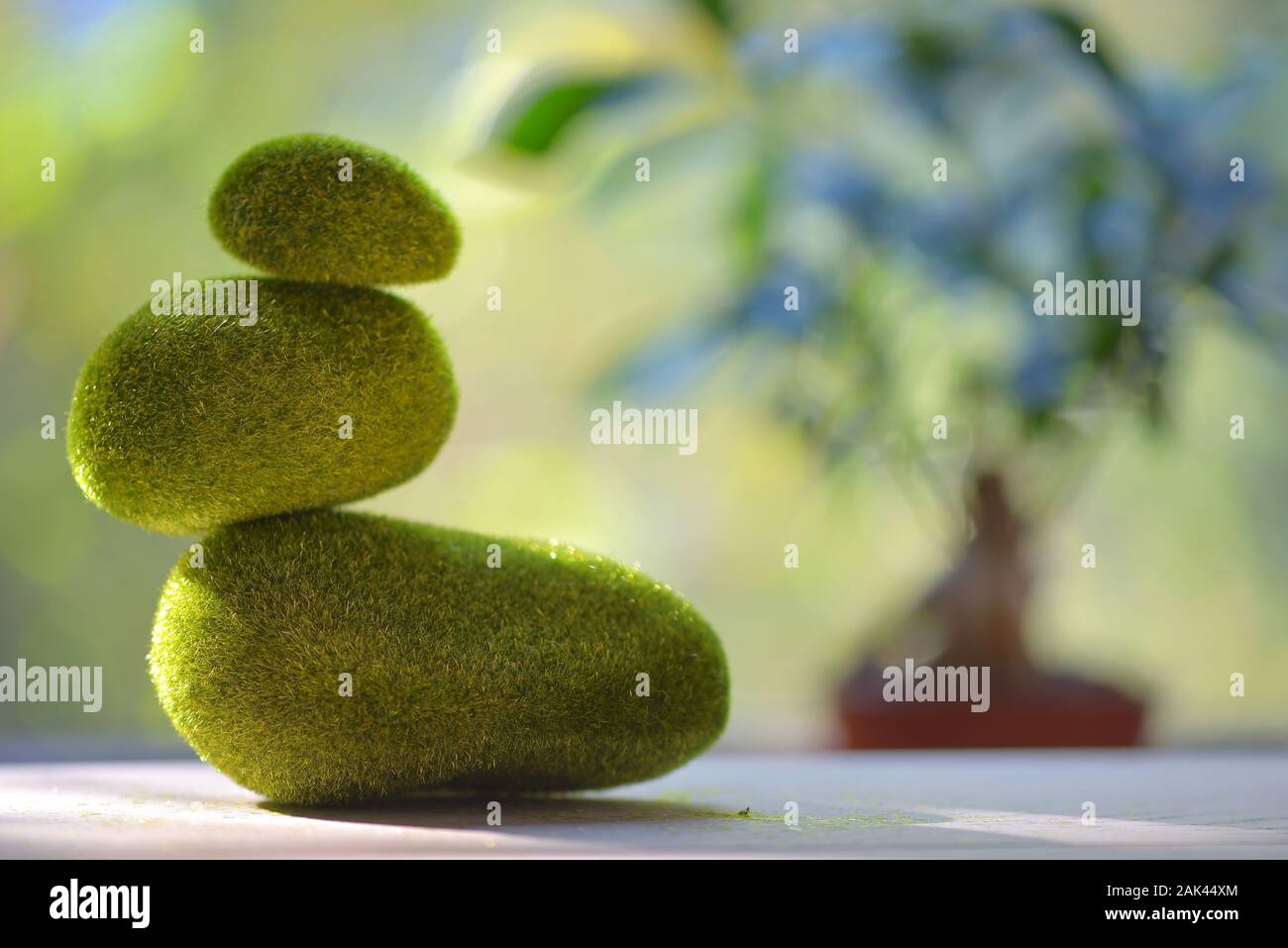 Erba verde pila di pietre ghiaia sul tavolo Foto Stock