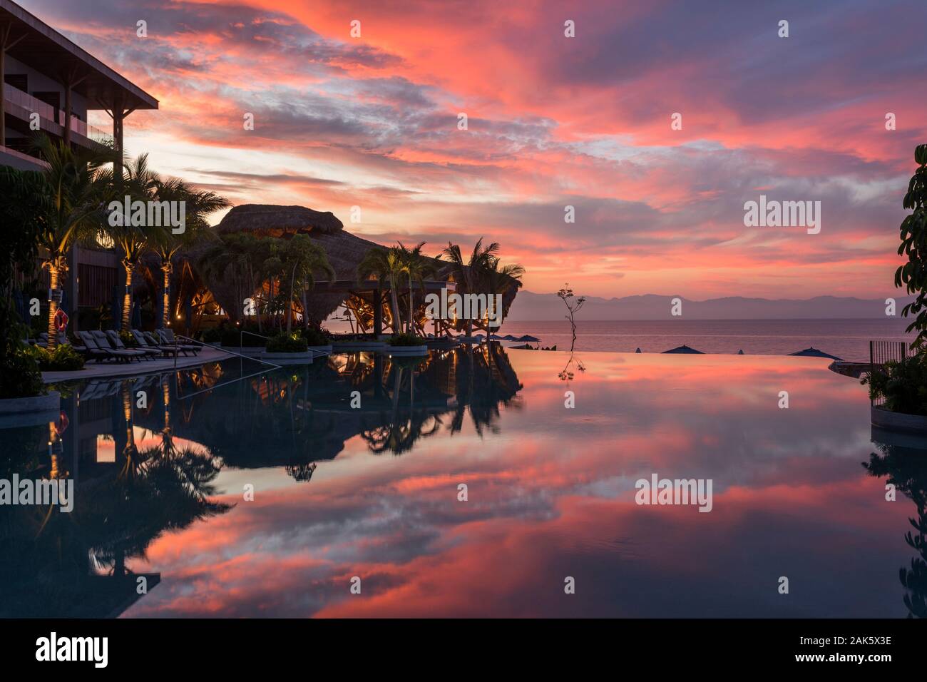 Messico,Nayarit,Nuevo Vallarta, colorato sunrise nuvole riflettono in una piscina a Marival Armony Resort Foto Stock