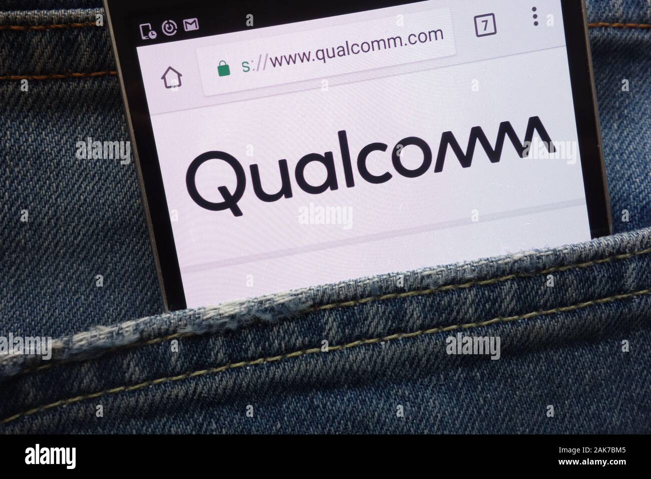Qualcomm sito web visualizzato sullo smartphone nascosto nella tasca dei jeans Foto Stock