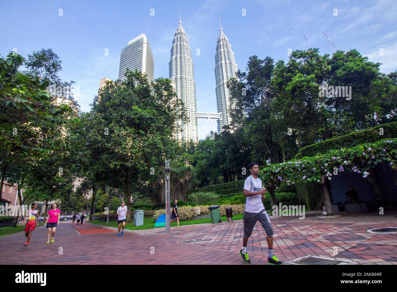 Persone jogging al Parco KLCC vicino le Torri Gemelle Petronas, motion blur per il pareggiatore Foto Stock