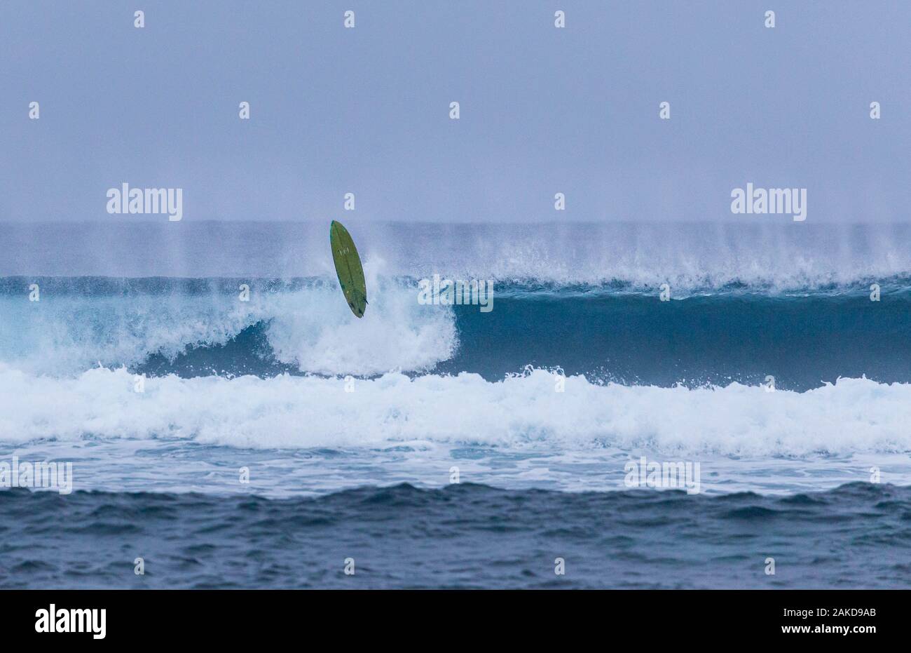Tavola da surf aleggia sulle onde di rottura dopo epic wipeout Foto Stock