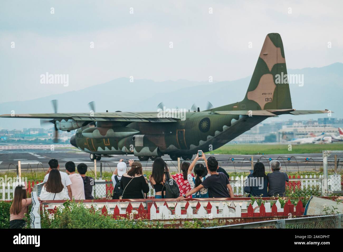 Una folla guarda come un aereo da carico della Repubblica della Cina Air Force Hercules C-130H si prepara per il decollo dall'Aeroporto di Songshan Foto Stock