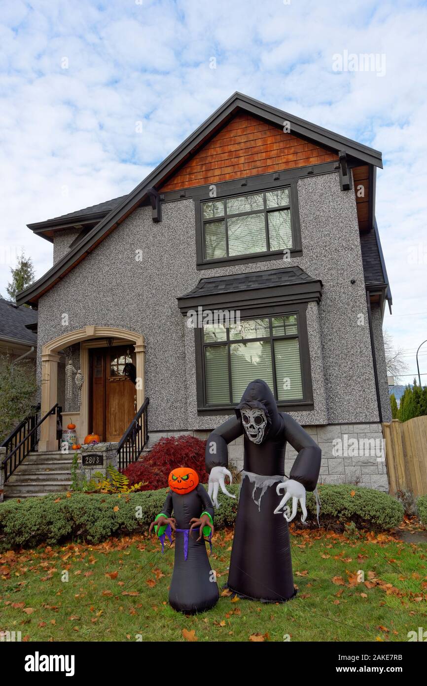 Ghoul Halloween figure al di fuori di un spooky cercando casa Foto Stock