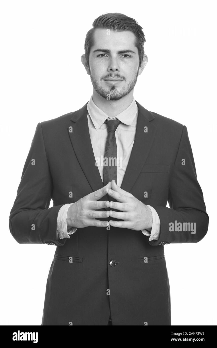 Giovane e bell'uomo d'affari caucasico intrecciando le dita insieme Foto Stock