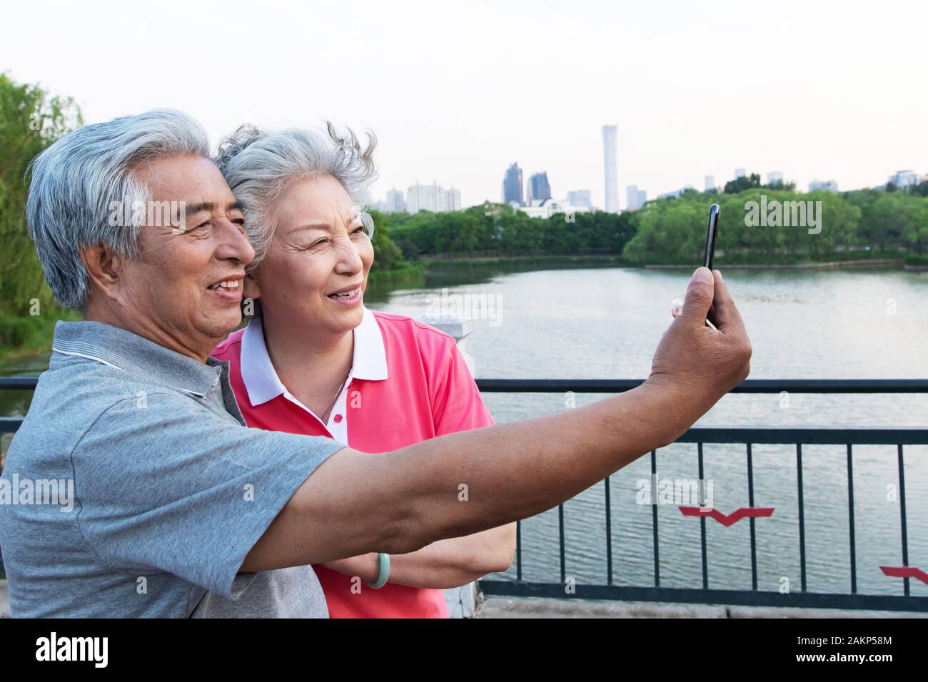 Coppia di anziani con i telefoni cellulari Foto Stock
