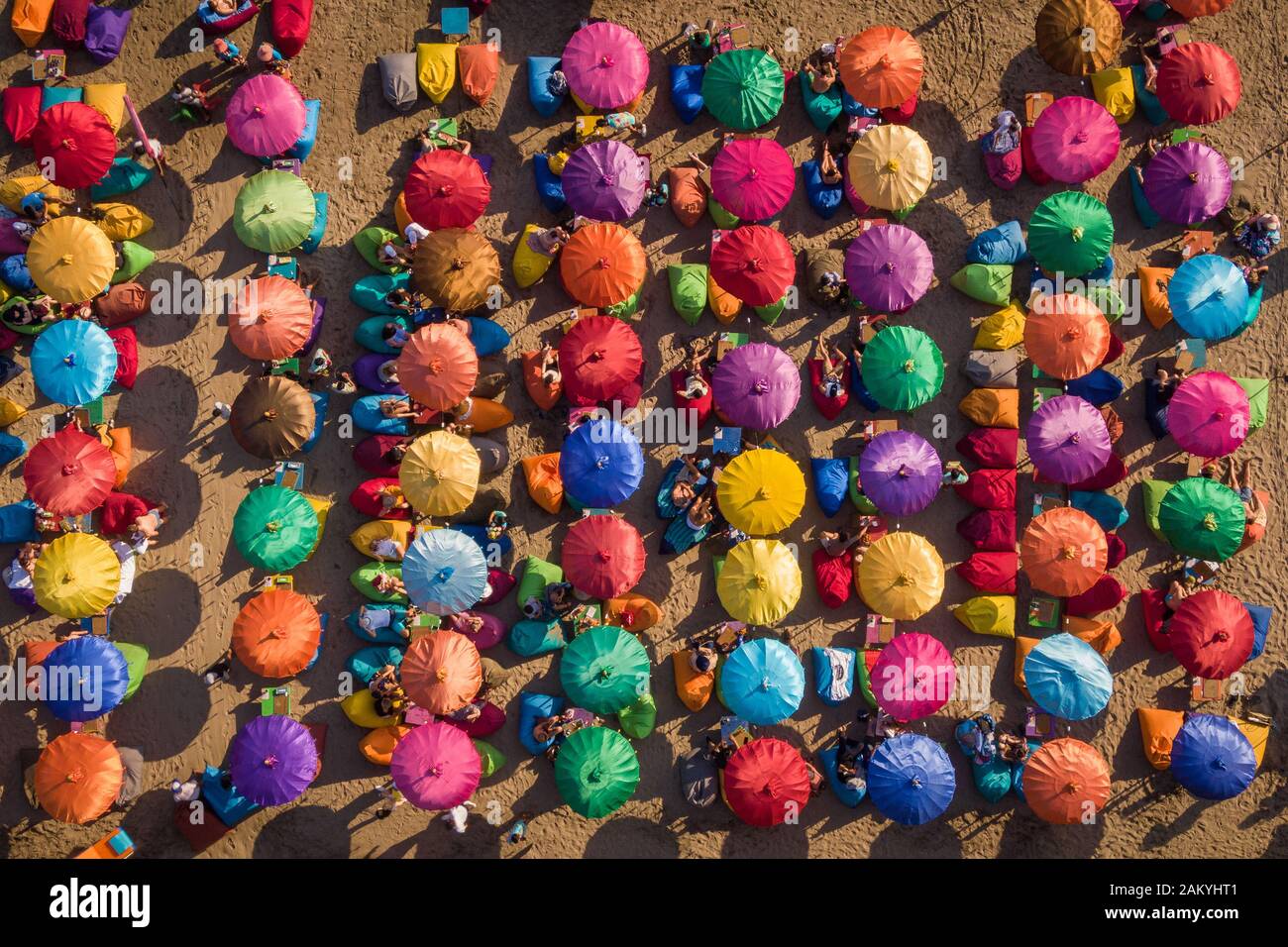 Vista aerea dall'alto dei colorati ombrelloni della famosa spiaggia di Seminyak a Bali, Indonesia. Foto Stock