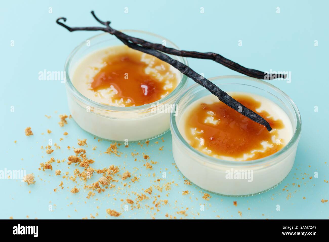 Vista in primo piano di due porzioni di dessert cremio bruleo condito con zucchero caramellato e vaniglia Foto Stock
