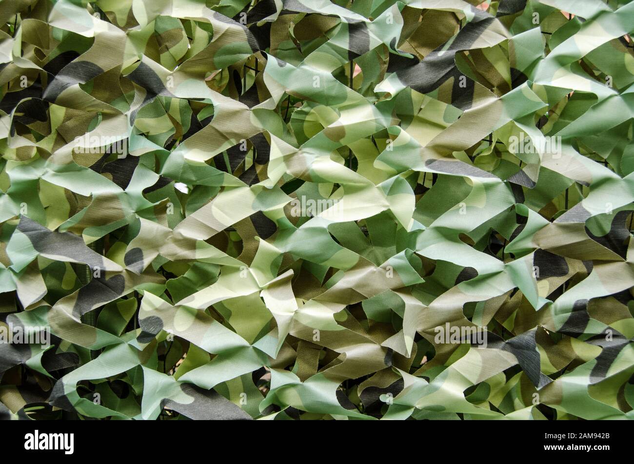 Tessuto camouflage che copre una recinzione da giardino per garantire la privacy. Foto Stock