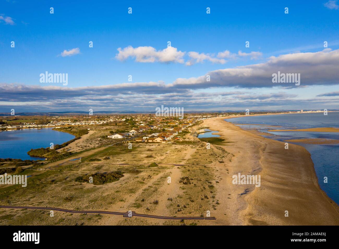 Pagham Village West End vicino alla riserva naturale Pagham Harbor vista aerea lungo la spiaggia in una giornata limpida e bella a gennaio. Foto Stock Pagham Village West End vicino alla riserva naturale Pagham Harbor vista aerea lungo la spiaggia in una giornata limpida e bella a gennaio. Foto Stock