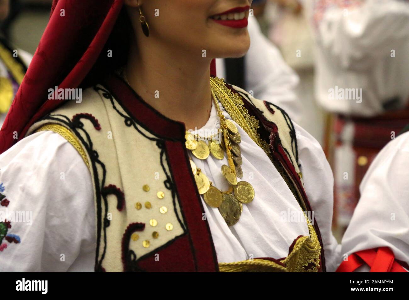 I ballerini professionisti del Timisul Folklore Ensemble tengono le mani in una danza tradizionale rumena indossando costumi tradizionali belli. Foto Stock