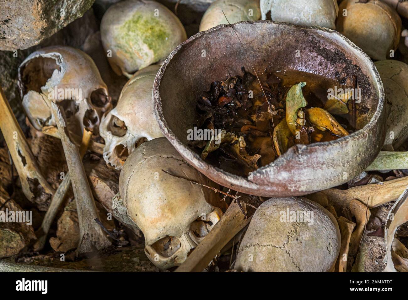 Teschi di cannibali lasciati dietro in una grotta sull'isola di Pana Vara Vara in Papua nuova Guinea Foto Stock