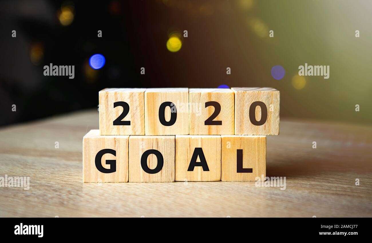 La sfida del nuovo anno, Tenendo Mano gli obiettivi 2020 su scatola di legno su sfondo di marmo, banner, business new year, mira al successo nel business Foto Stock