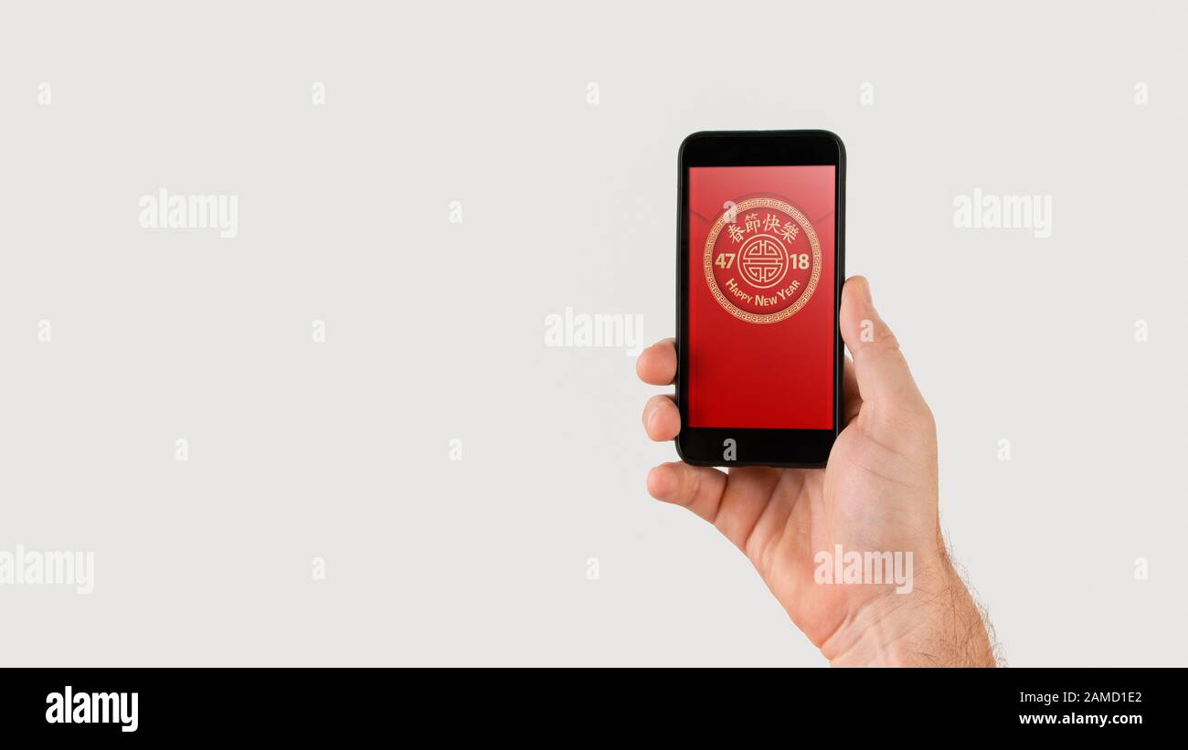 Tenere a mano lo smartphone con pacchetto digitale rosso per il nuovo anno cinese visualizzato sullo schermo - feste e concetto di tecnologia. Foto Stock