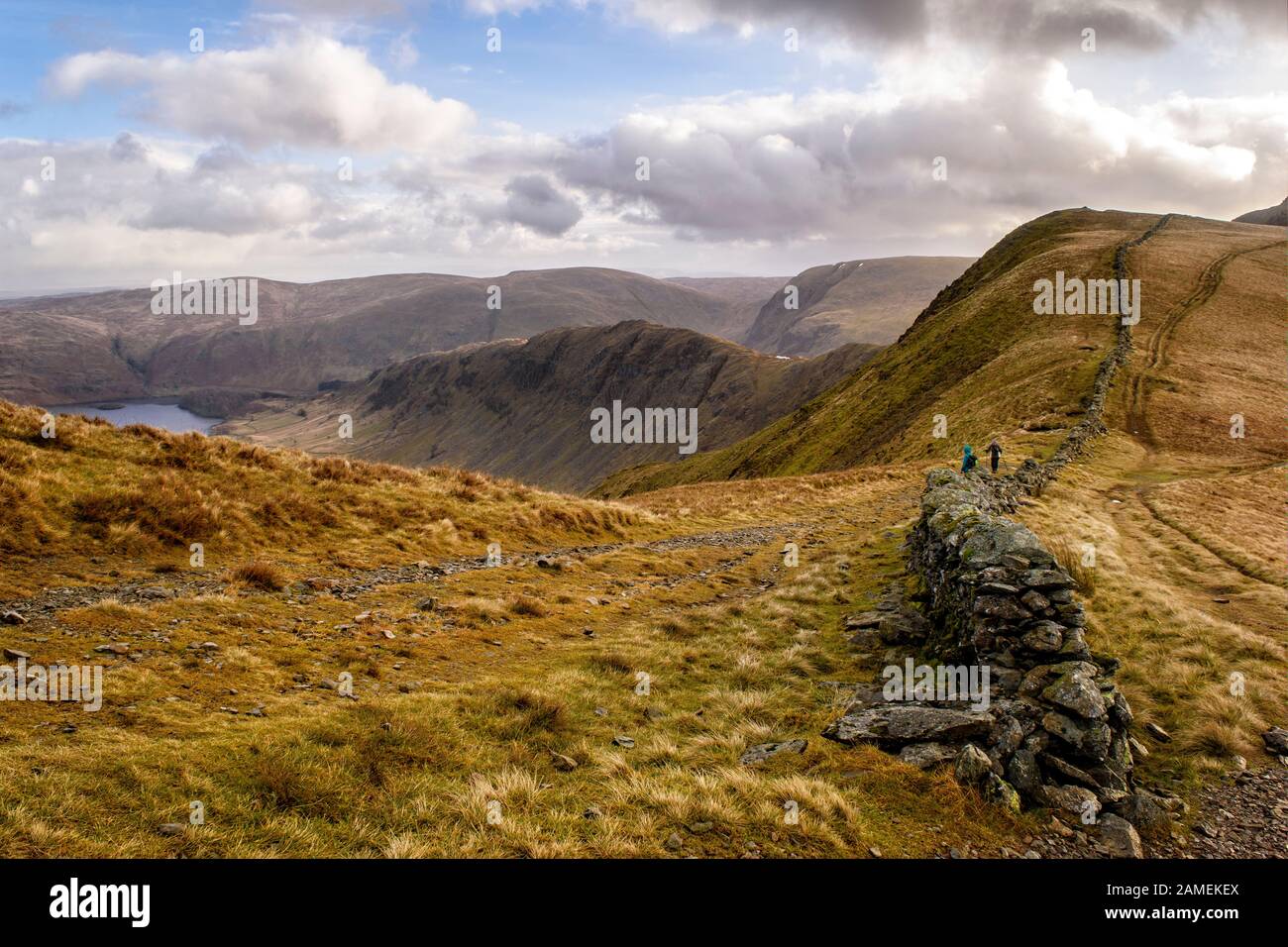 Camminatori seguendo la vecchia strada romana lungo High Street con vedute di Haweswater e Riggingdale Foto Stock