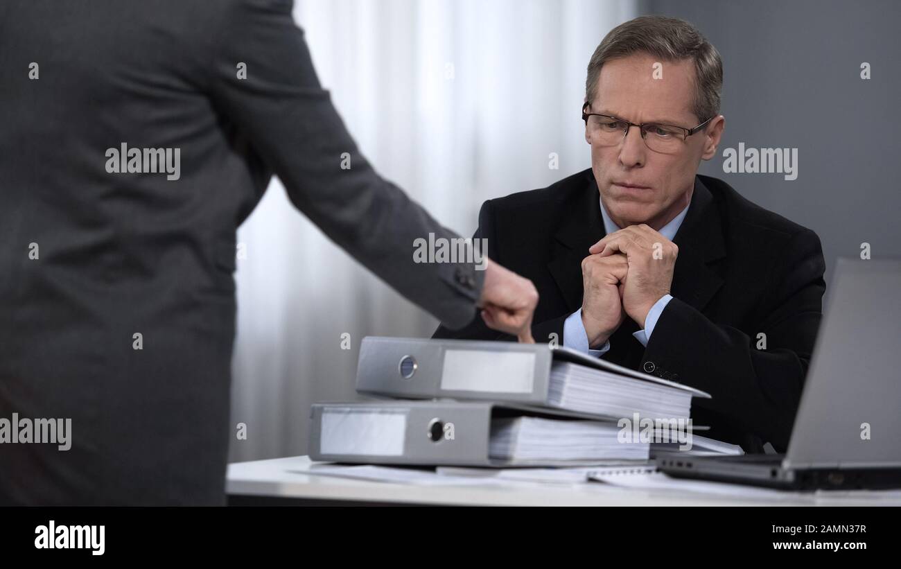 Donna d'affari che punta a casi con lavoro supplementare, richieste elevate all'assistente Foto Stock