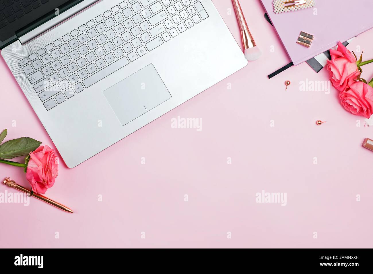 Scrivania femminile concetto di area di lavoro. Vista superiore del  portatile, colore oro cancelleria e rose rosa sul tavolo Foto stock - Alamy