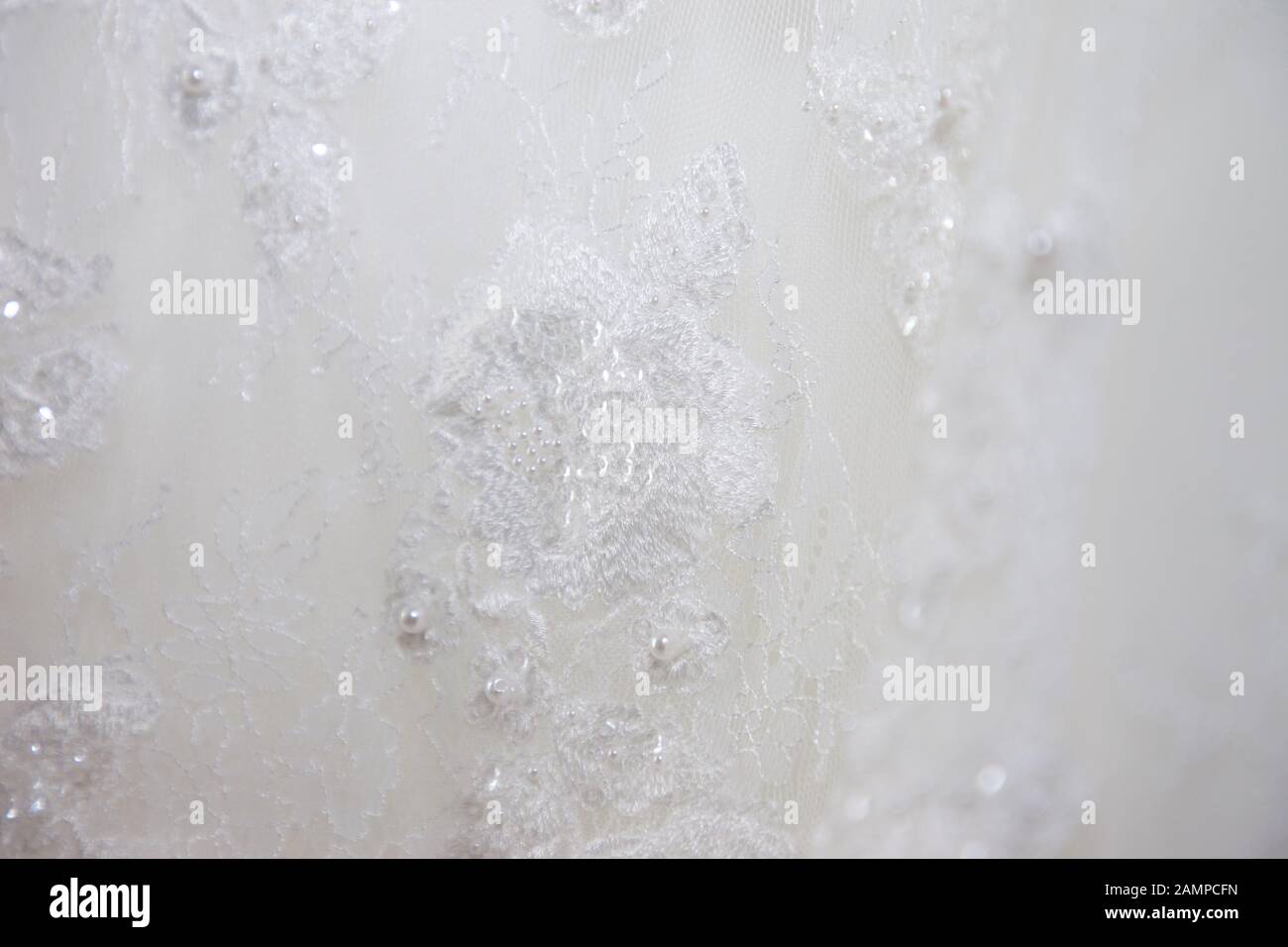 Close up del laccio dettaglio su un abito da sposa. Foto Stock