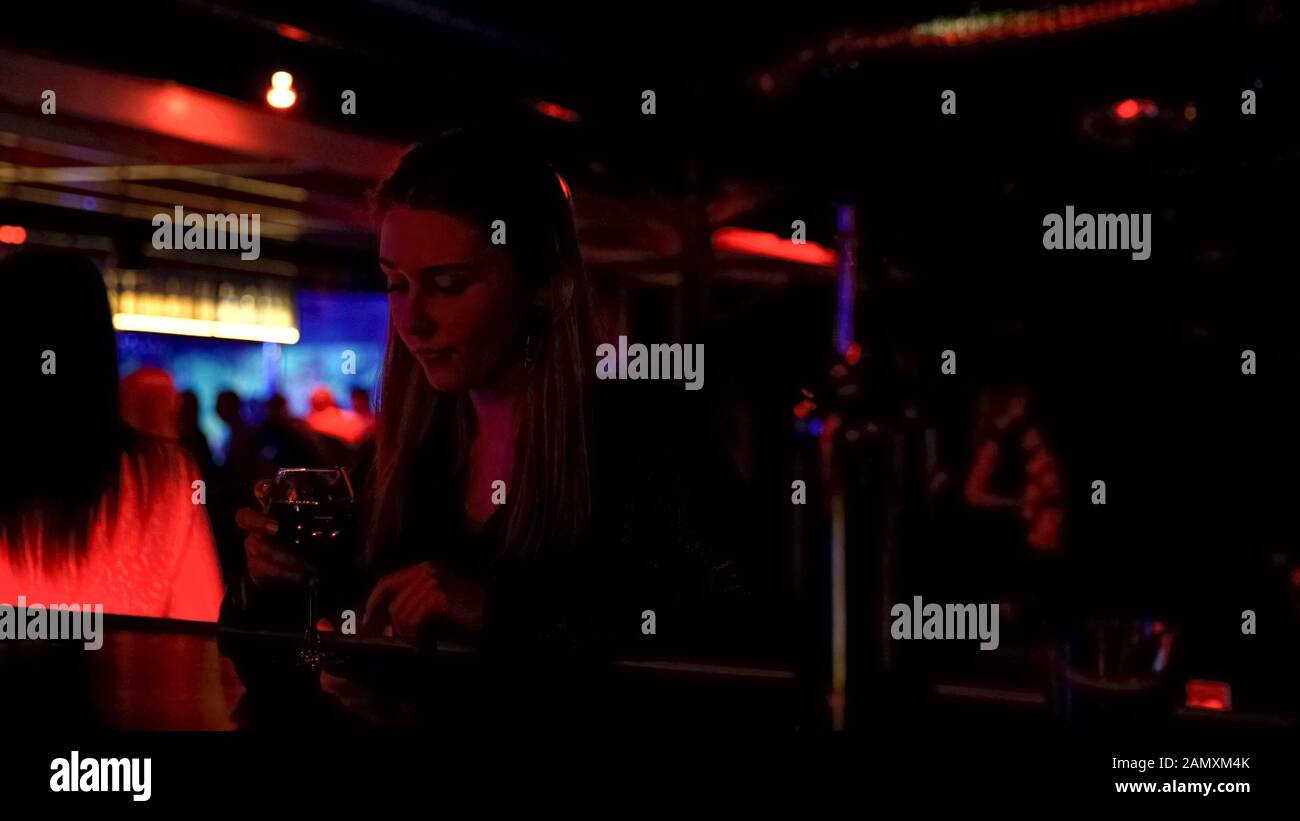 Signora solitaria sconvolta bere vino al bancone del bar nel night club, problemi di vita Foto Stock