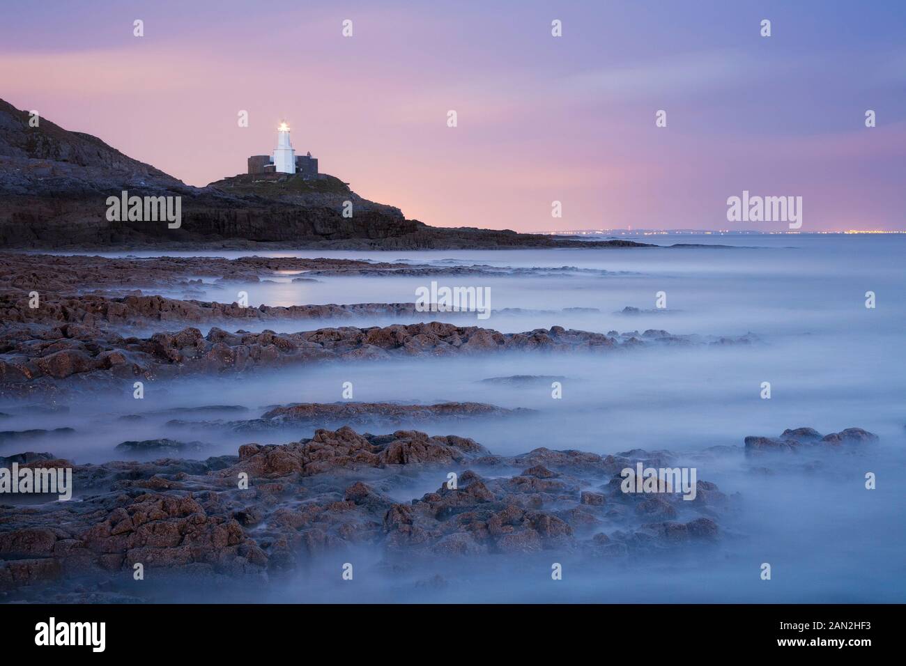 Mumbles faro al tramonto, Swansea Bay, GLAMORGAN, GALLES Foto Stock