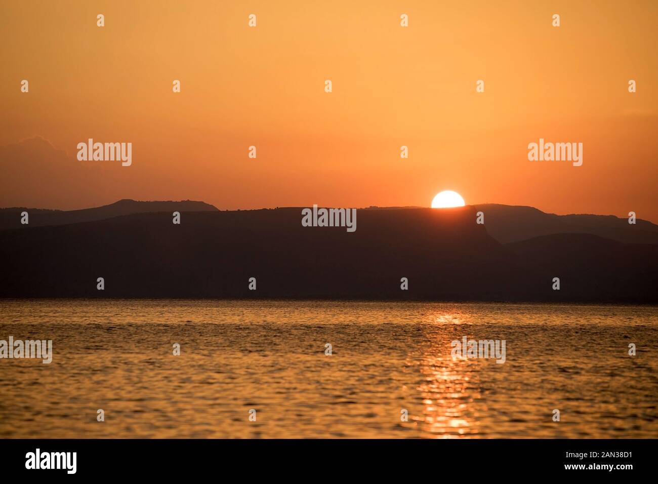 Il sole sorge sul Mare di Galilea, il più grande lago d'acqua dolce d'Israele Foto Stock