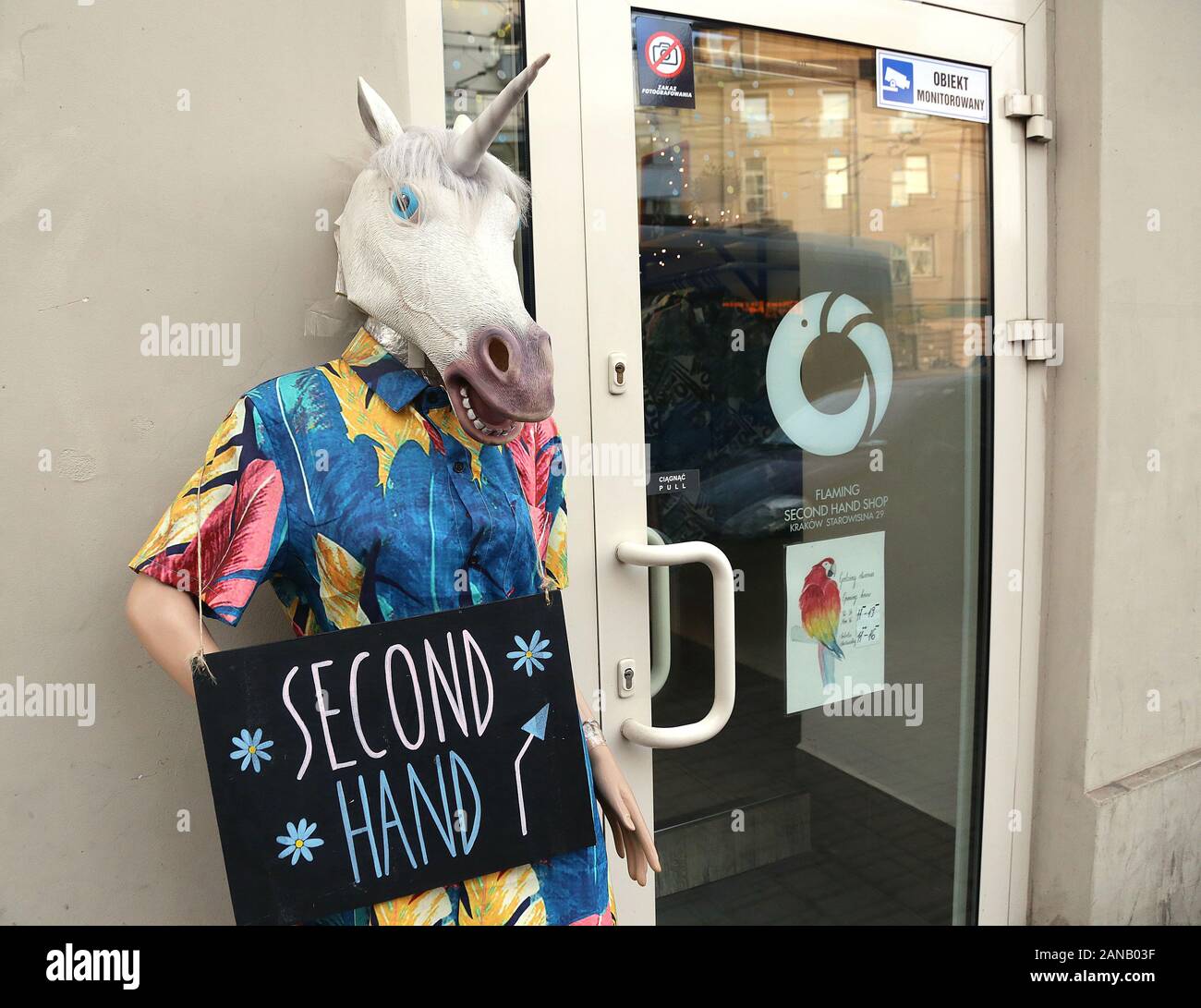 Cracovia. Cracovia. La Polonia. Shop manichino nella maschera unicorno nella parte anteriore di seconda mano negozio di abbigliamento. Foto Stock