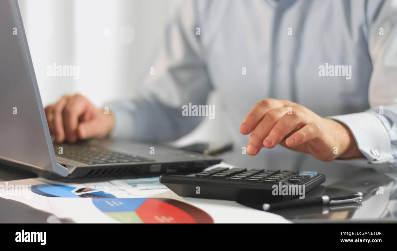 Imprenditore notebook di lavoro calcolo dati fiscali per relazione contabile della società Foto Stock