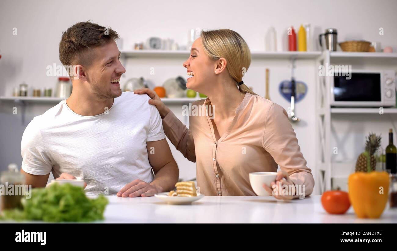 Positivo coppia giovane ridendo come avente la colazione, ingannare intorno insieme Foto Stock