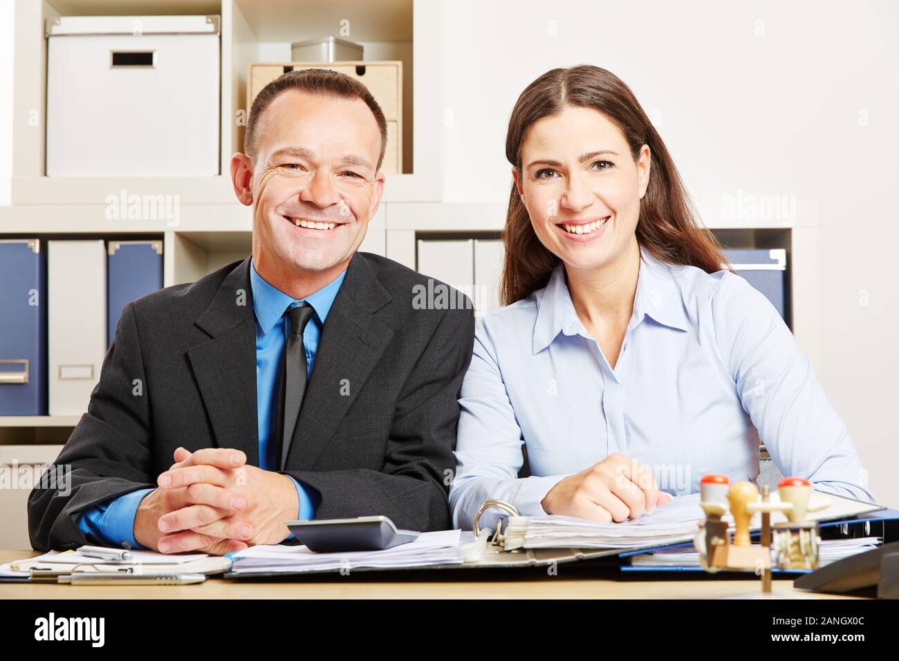 L uomo e la donna sono seduti insieme in ufficio in una scrivania Foto Stock