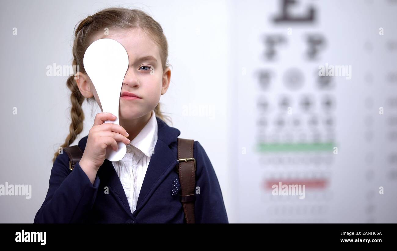 Da studentessa di chiudere un occhio per la visione completa exam, diagnostica della vista Foto Stock