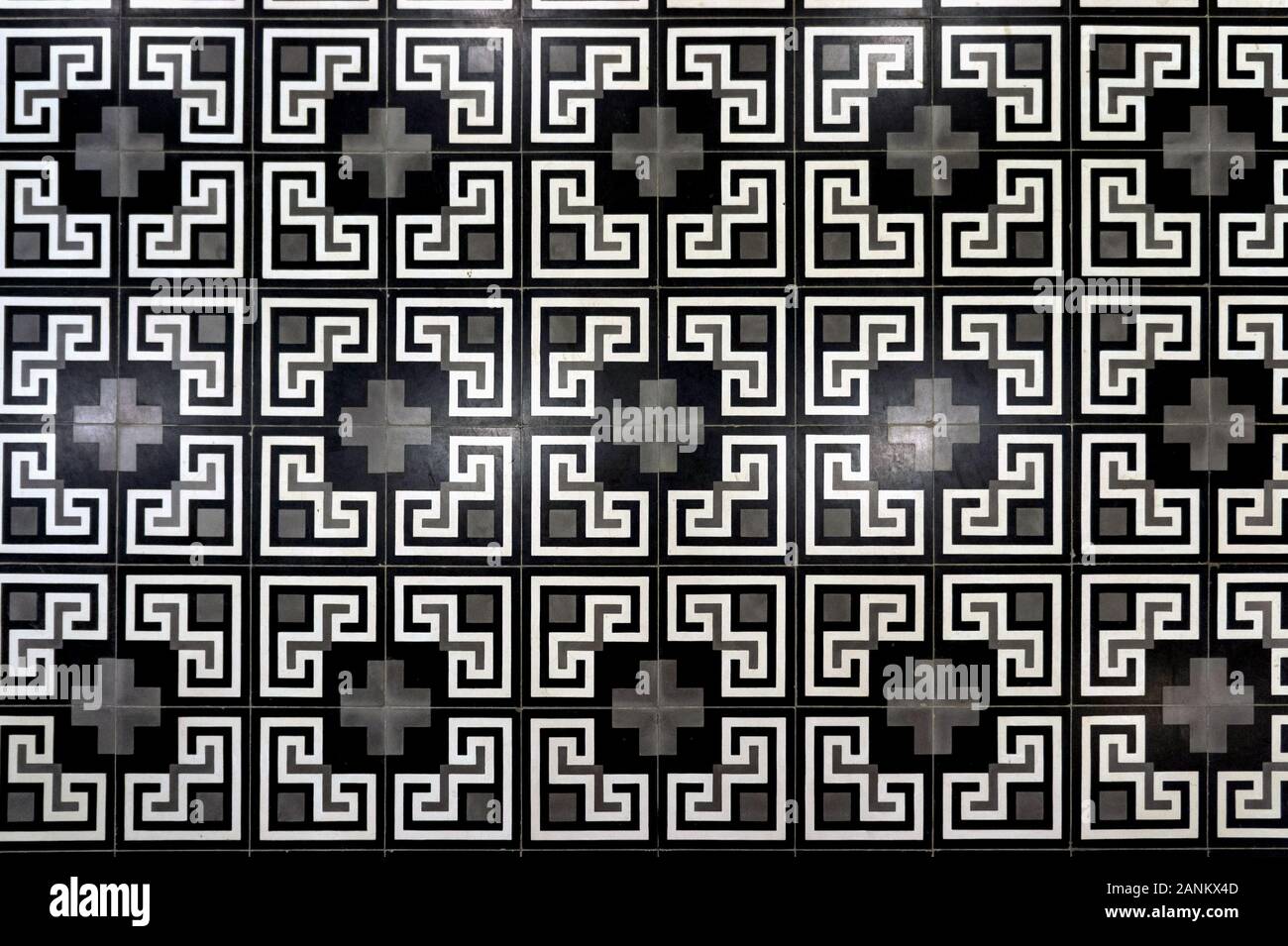 Vintage piastrelle da pavimento. Geometrico ornamento angolare. Retro bianco grigio. Fotografato in Vietnam presso la stazione della funicolare Foto Stock