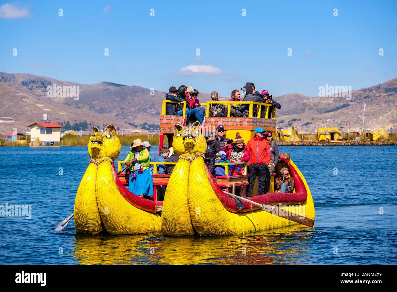 Totora reed boat che trasportano i turisti, Uros isole galleggianti, il lago Titicaca, Puno, Perù Foto Stock