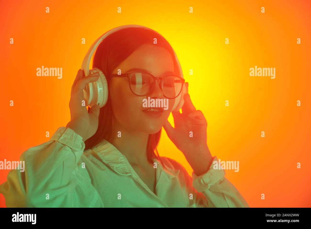 Donna felice nelle cuffie Foto Stock